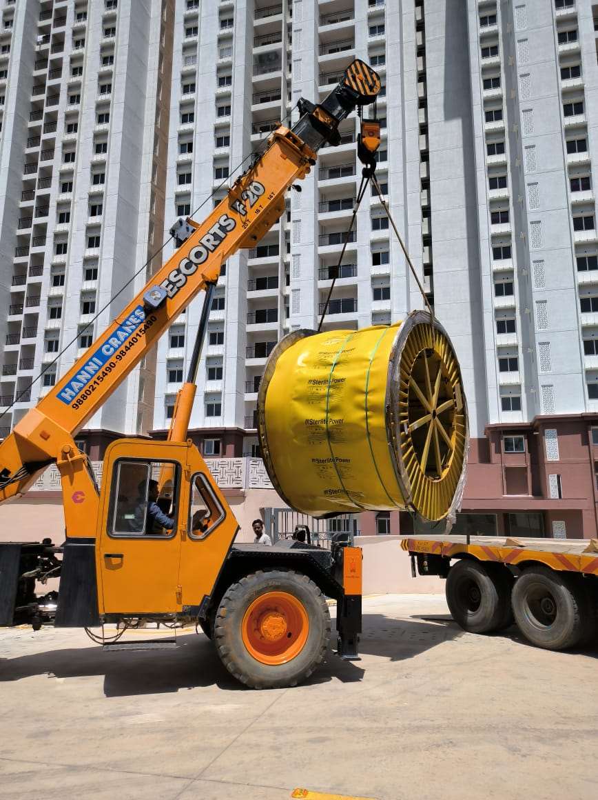 Crane lifting a large cable drum